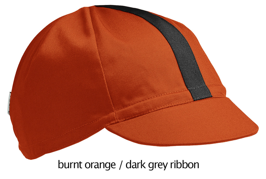 flat shot of the 4-panel cotton cap in burnt orange with a dark grey ribbon