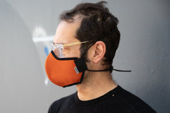 Profile shot of Matt wearing the organic summer cotton mask in burnt orange