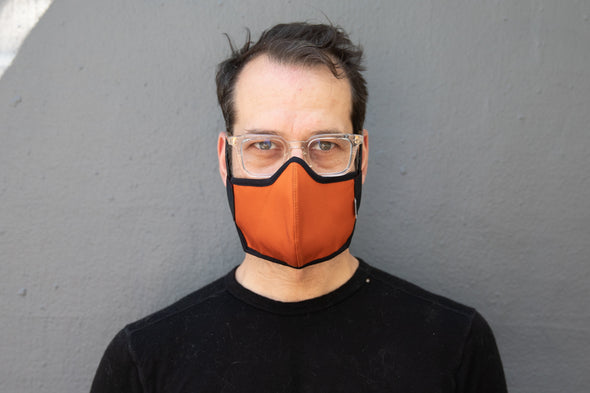 Matt is wearing the organic summer cotton mask in burnt orange