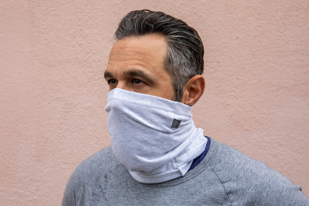 a model wearing the heather white neck gaiter