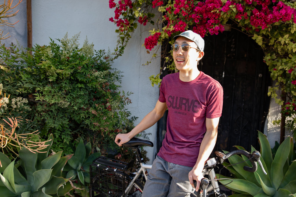 Teddy in a classic cotton/poly 1968 swrve logo t-shirt in crushed berry heather.