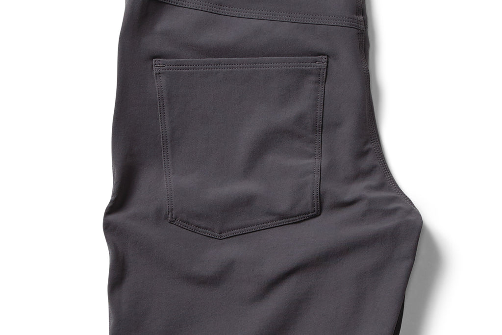 flat shot rear pocket detail of the TRANSVERSE slim trousers in grey